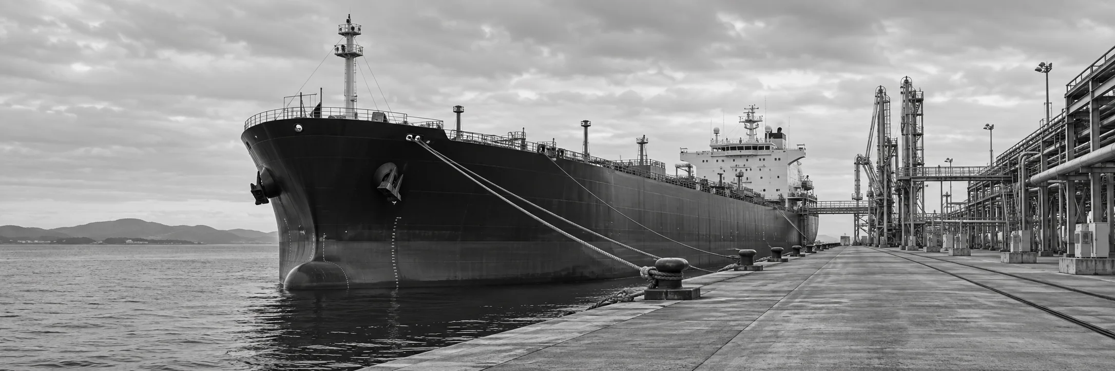 Commercial vessel alongside an industrial quay